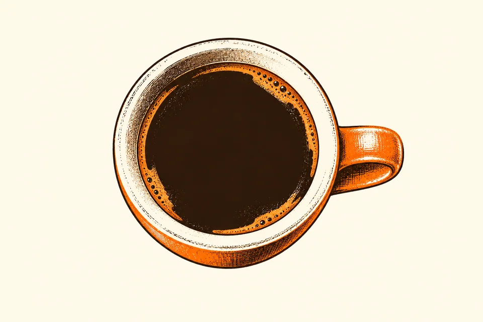 An overhead espresso cup has a thin broken crema ring around dark coffee.